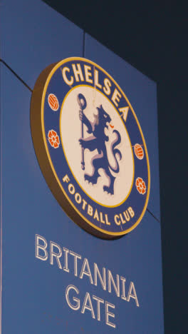 Vertical-Video-Exterior-Of-Stamford-Bridge-Stadium-Home-Ground-Of-Chelsea-Football-Club-London-At-Night-9